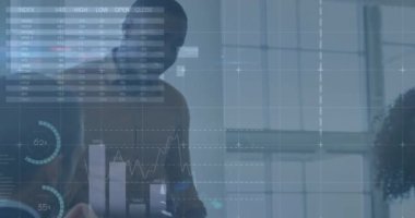 Animation of financial data and graphs over happy diverse businesspeople talking in office. business, finance, economy and technology concept digitally generated video.
