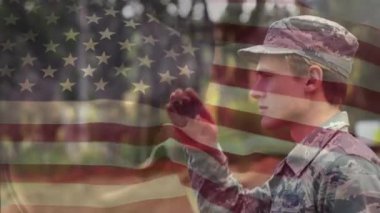 Animation of flag of usa over caucasian male soldier saluting. patriotism and celebration concept digitally generated video.