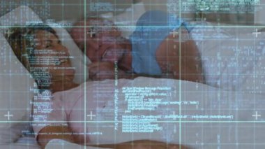 Animation of data processing over caucasian senior couple talking in bed. senior health, well being, medicine and technology concept digitally generated video.