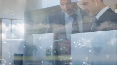 Molecular structures over two caucasian businessmen using digital tablet against clouds in the sky. global networking and business technology concept