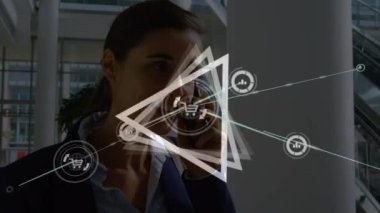 Abstract triangular shape spinning against caucasian businesswoman talking on smartphone. global networking and business technology concept