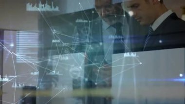 Network of connections and data processing against two caucasian businessmen using digital tablet. global networking and business technology concept