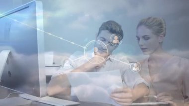 Network of profile icons against caucasian couple calculating finance against clouds in the sky. family budget and global networking technology concept