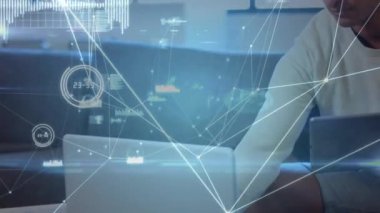 Network of connections and data processing against biracial man man using laptop and digital tablet. global networking and business technology concept