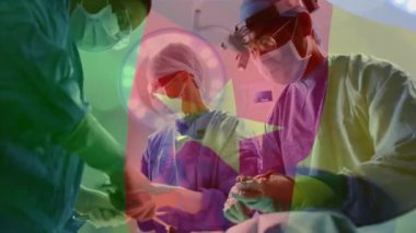 Ameliyat sırasında çeşitli doktorların üzerinde kamerun bayrağı animajı. küresel tıp ve vatanseverlik kavramı dijital olarak üretilen video.