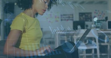 Animation of data processing over biracial businesswoman using laptop. global business and digital interface concept digitally generated video.
