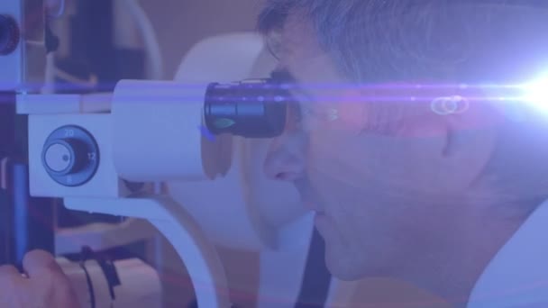 Animation Light Trails Diverse Doctor Patient Using Slit Lamp Global — Stock Video