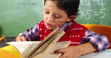Animation of math formulas over focused caucasian boy learning at school. learning, education and school concept digitally generated video.