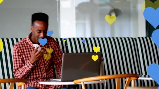 Multiple Yellow Blue Heart Icons Floating African American Man Talking — Αρχείο Βίντεο