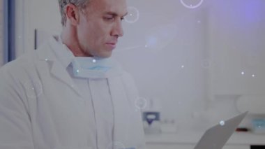 Animation of data processing over biracial male dentist with face mask. Global business and digital interface concept digitally generated video.