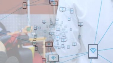 Network of digital icons against mid section of a female doctor holding a clipboard at hospital. Medical healthcare and global networking technology concept