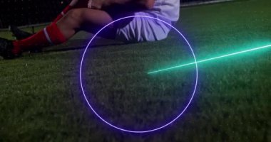 Animation of neon shapes over biracial football player at stadium. Global sport and digital interface concept digitally generated video.