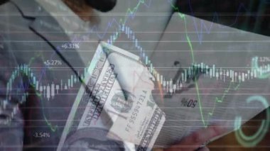Financial data processing and burning american dollar over biracial businessman reading newspaper. Global finance and business technology concept