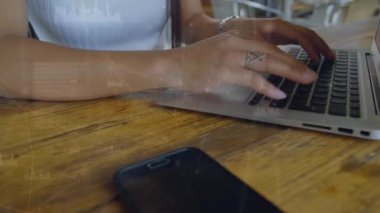 Animation of connections over hands of biracial woman using laptop. Network, connections, communication and working with technology concept digitally generated video.