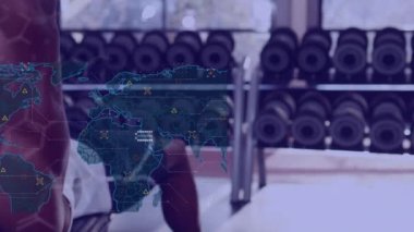Animation of data processing over african american man exercising at gym. Global sport and digital interface concept digitally generated video.