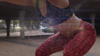 Animation of network of connections over midsection of fit biracial woman doing squats. Sport, active lifestyle, connections and technology concept digitally generated video.