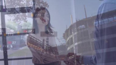 Animation of social media reactions and caucasian businesspeople shaking hands over building site. global connections, cooperation in business and technology concept digitally generated video.