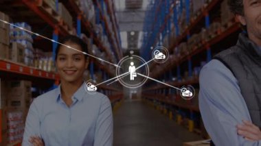 Animation of network of connections with icons over happy diverse warehouse workers. business, connections, technology and delivery services concept digitally generated video.