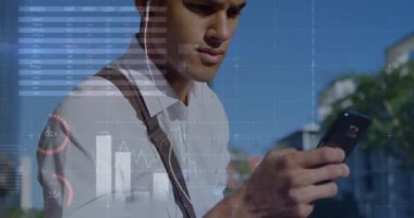 Animation of graphs over midsection of biracial man using smartphone. economy, finance, communication and technology concept digitally generated video,
