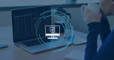 Animation of computer icon over caucasian businesswoman using laptop in office. Global business and digital interface concept digitally generated video.