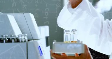 Kimyasal formüllerin animasyonu beyaz erkek laboratuvar işçisinin elinde numuneyle. Bilim, kimya ve tıp konsepti dijital olarak üretilen video.