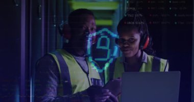 Animation of data processing over african american couple using laptop in server room. Cloud computing, digital interface and security concept digitally generated video.
