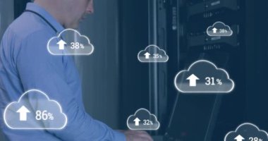 Animation of cloud icons with growing numbers over caucasian man in server room. global technology, data processing and digital interface concept digitally generated video.