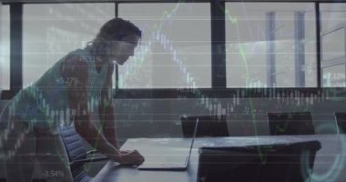 Animation of financial data over caucasian businesswoman working on laptop in office. economy, finance, business and technology concept digitally generated video.