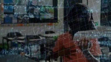 Animation of mathematical equations over african american schoolboy using vr headset. global education, technology and digital interface concept digitally generated video.