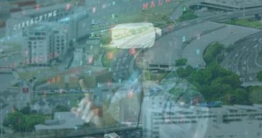 Animation of data processing and virus warning over caucasian man in vr headset and cityscape. Network, data processing, digital security and technology concept digitally generated video.