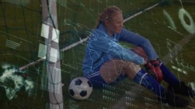 Animation of data processing over female caucasian football player on football pitch. global sports, competition and data processing concept digitally generated video.