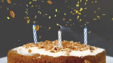 Animation of balls and confetti falling over birthday cake. animation of leaves appearing over sprinkles falling on white surface.