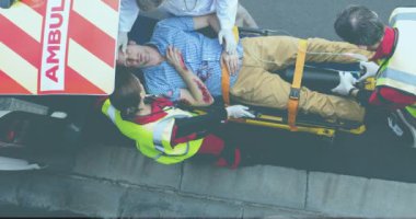 Animation of diverse paramedics with patient and ambulance. Emergency number day and celebration concept digitally generated video.