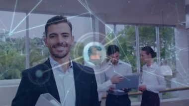 Network of profile icons floating against portrait of caucasian businessman smiling at office. Global networking and business technology concept