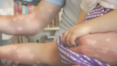 Kafkasyalı baba ve çocuğun dizüstü bilgisayarda çalışırken kalp animasyonu. Ebeveynlik, çocuk büyütmek ve dijital olarak üretilen ev konsepti üzerinde çalışmak.