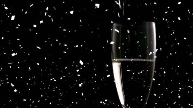 Animation of glass of champagne over dark background. new years eve party and celebration concept digitally generated video.