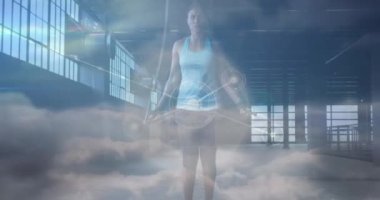 Animation of network of connections over clouds and fit afrcian american woman jumping. Sport, active lifestyle, communication and connections concept digitally generated video.