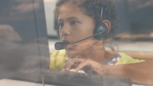 African American Boy Wearing Phone Headset Using Computer School Clouds — Stock Video