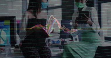 Animation of financial data processing over diverse group of business people wearing face masks. Global business, finances during covid 19 pandemic concept digitally generated video.
