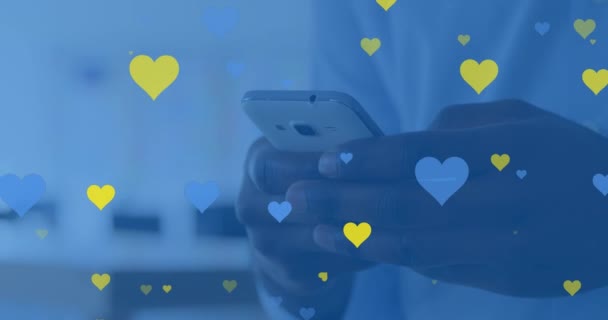 Animation Yellow Blue Hearts Floating Hands Biracial Man Using Smartphone — Stok video