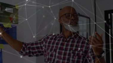 Animation of network of connections over senior african american man making presentation. Network, connections, business and technology concept digitally generated video.