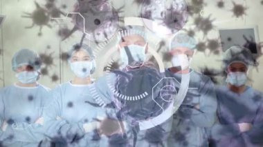 Animation of scope and covid 19 cells over diverse surgeons wearing face masks in operating theatre. global covid 19 pandemic, medicine and healthcare services concept digitally generated video.