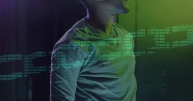 Animation of chain over african american man using vr headset in server room. Cloud computing, digital interface and security concept digitally generated video.