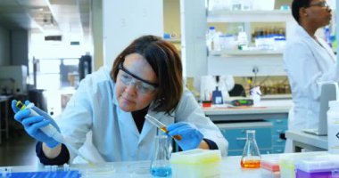 Animation of padlock over caucasian female scientist in lab. global science and digital interface concept digitally generated video.