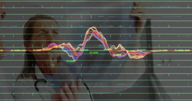 Animation of financial graphs over thoughtful caucasian male and female doctor. Health, medicine, finance and economy concept digitally generated video.