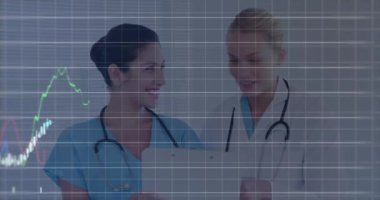 Animation of financial data processing over two caucasian female doctors. Global medicine, technology, data processing and digital interface concept digitally generated video.