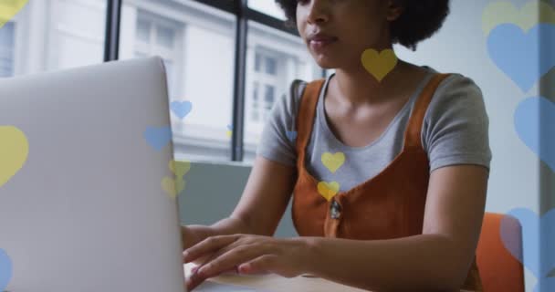 Animation Hearts Falling African American Woman Using Laptop Global Business — Stock video