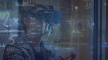 Animation of data processing over caucasian men using vr headset. global connections, data processing and technology concept digitally generated video.