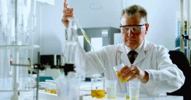 Animation of mathematical equations over caucasian male scientist in lab. global science and digital interface concept digitally generated video.