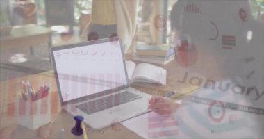 Animation of graphs and virus cells over biracial woman using laptop with copy space. global business, economy and technology during coronavirus covid 19 pandemic concept digitally generated video.